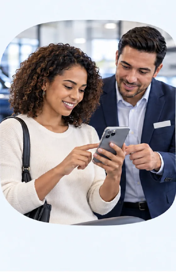 A customer opens the VinTraxx Capital application on a phone while a specialist looks on.