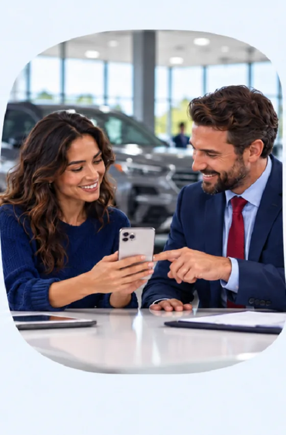 A shopper and a dealership team member reviewing a saved vehicle together on a phone.